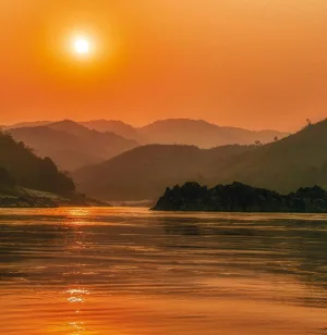 Photograph of an Asian coastline against an orange sunset