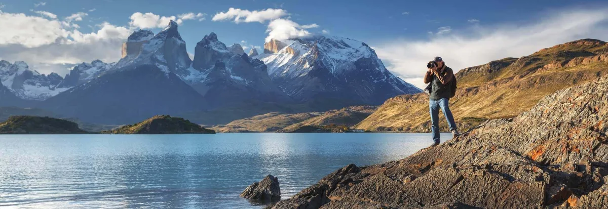 A hiker overlooks the water with stunning views of the South American landscape