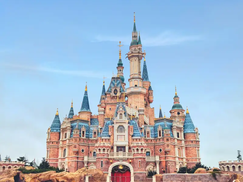 Photograph of Disneyland's iconic castle against a clear blue sky